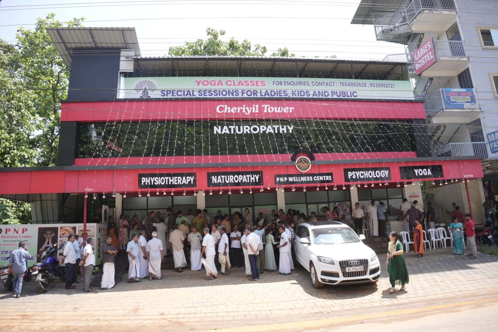 Front of PNP Wellness Center showing people gathered for ceremony